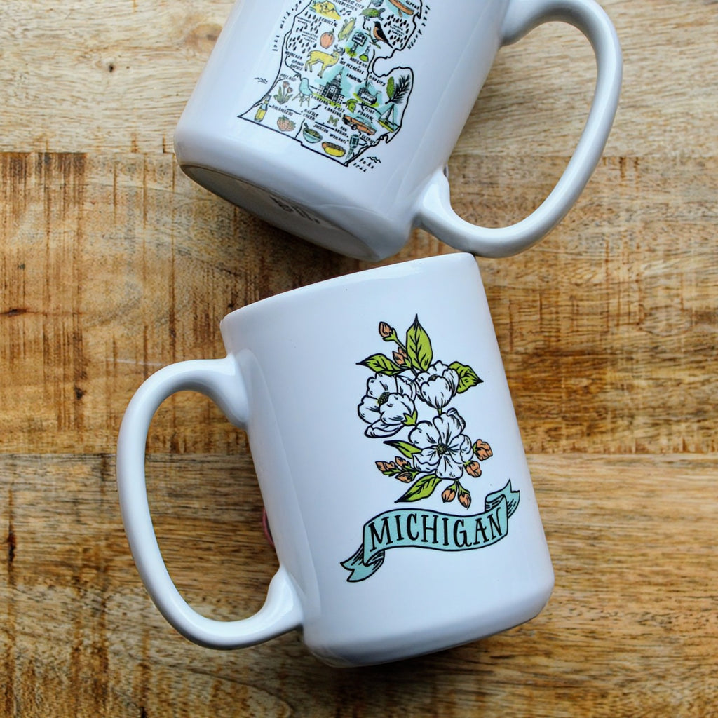 White ceramic mug with an illustrated map of Michigan