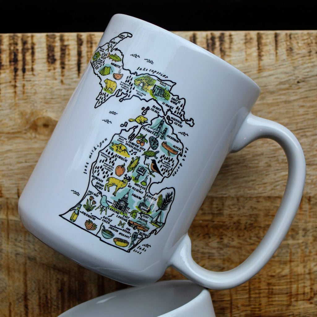 White ceramic mug with an illustrated map of Michigan