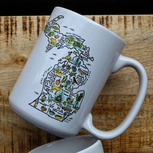 White ceramic mug with an illustrated map of Michigan
