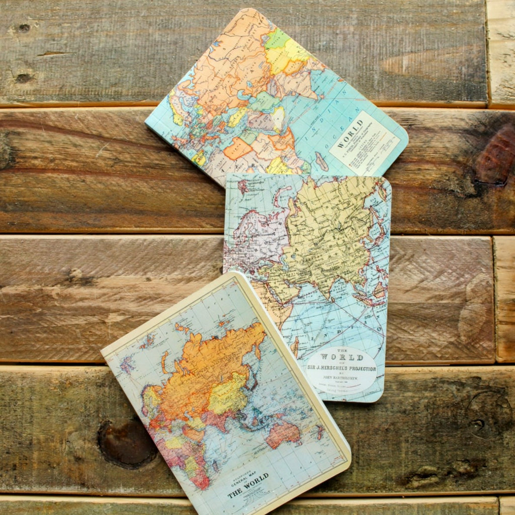 World Maps Mini Notebook Set featuring three vintage-style map covers, including historical country borders. Laying on desk.
