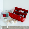 Red toolbox with various items on a white surface