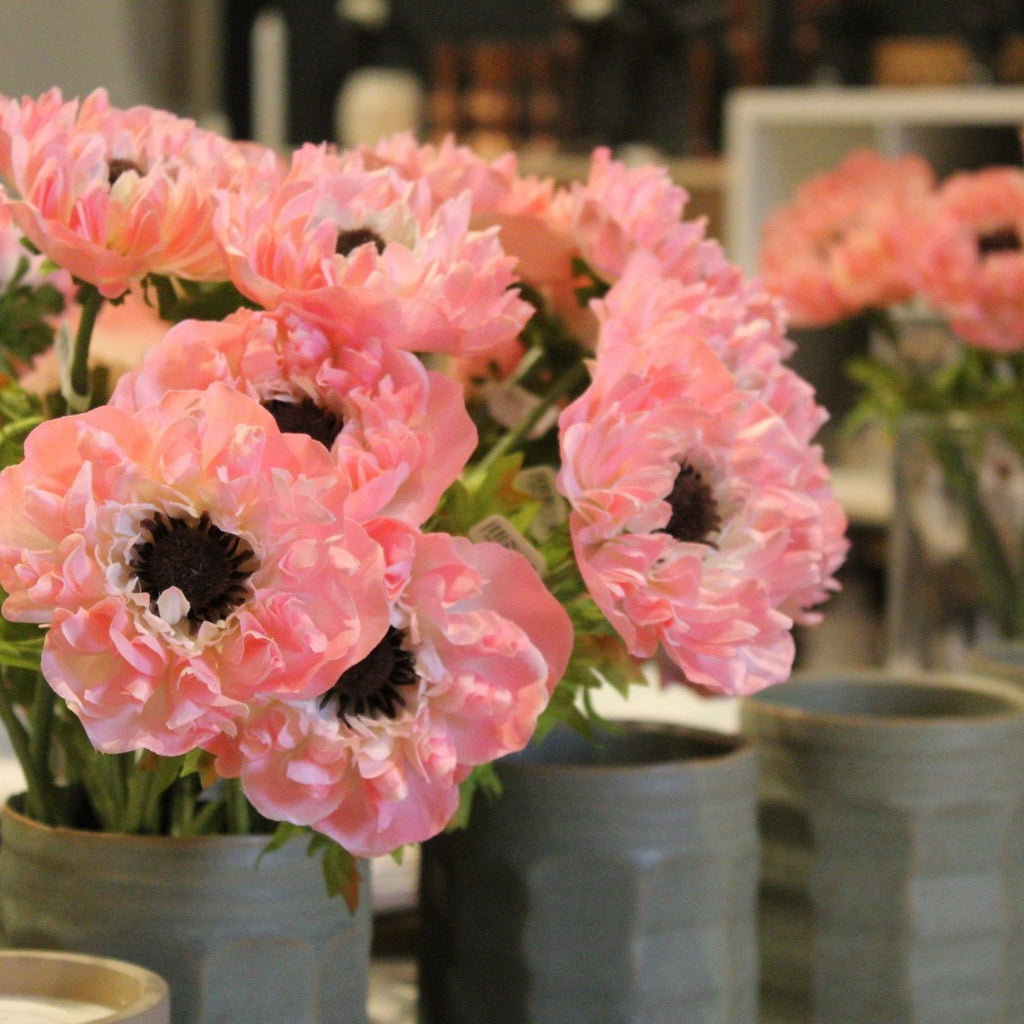 large group of pink Anemone stems in green vase