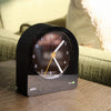 focused photo of black Braun BC22 Classic Analogue Alarm Clock in a living room 