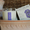 Lavender scented soy candle featuring lavender on a decorative surface.