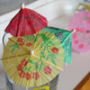 close up view of the colorfully decorated paper drink umbrellas in a glass