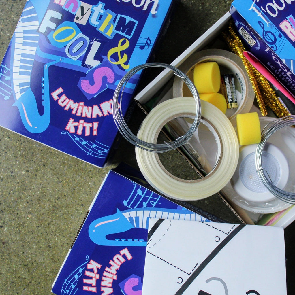 FoolMoon Luminary kits laid out. One open to show the contents including wire, tape, batteries. Everything you need to create your own saxophone luminary. 