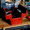 Red toolbox on a wooden surface with a workshop background